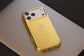 Gold phone case with crocodile texture on a light gray surface