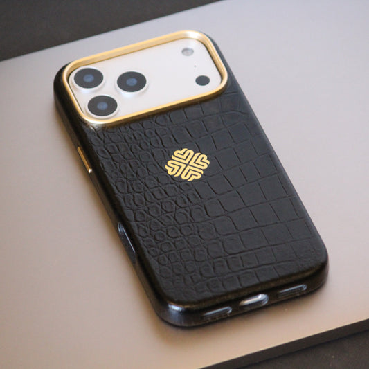 Black textured leather phone case with gold accents on a light gray surface